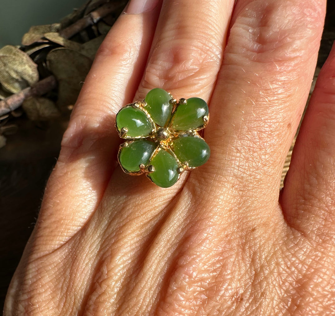 Vintage jade ring with five heart shaped green cabochons forming a clover on a gold setting.