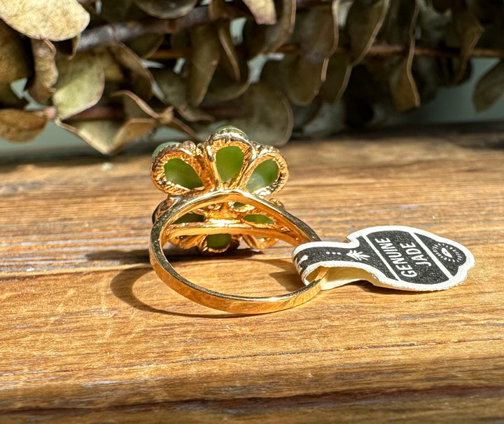 Close up of Vintage Jade Ring showing green jade petals and a gold band with a Genuine Jade tag visible.