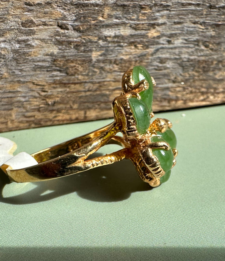 Side view of Vintage Jade Ring with a green jade cluster set in gold and carved detailing.