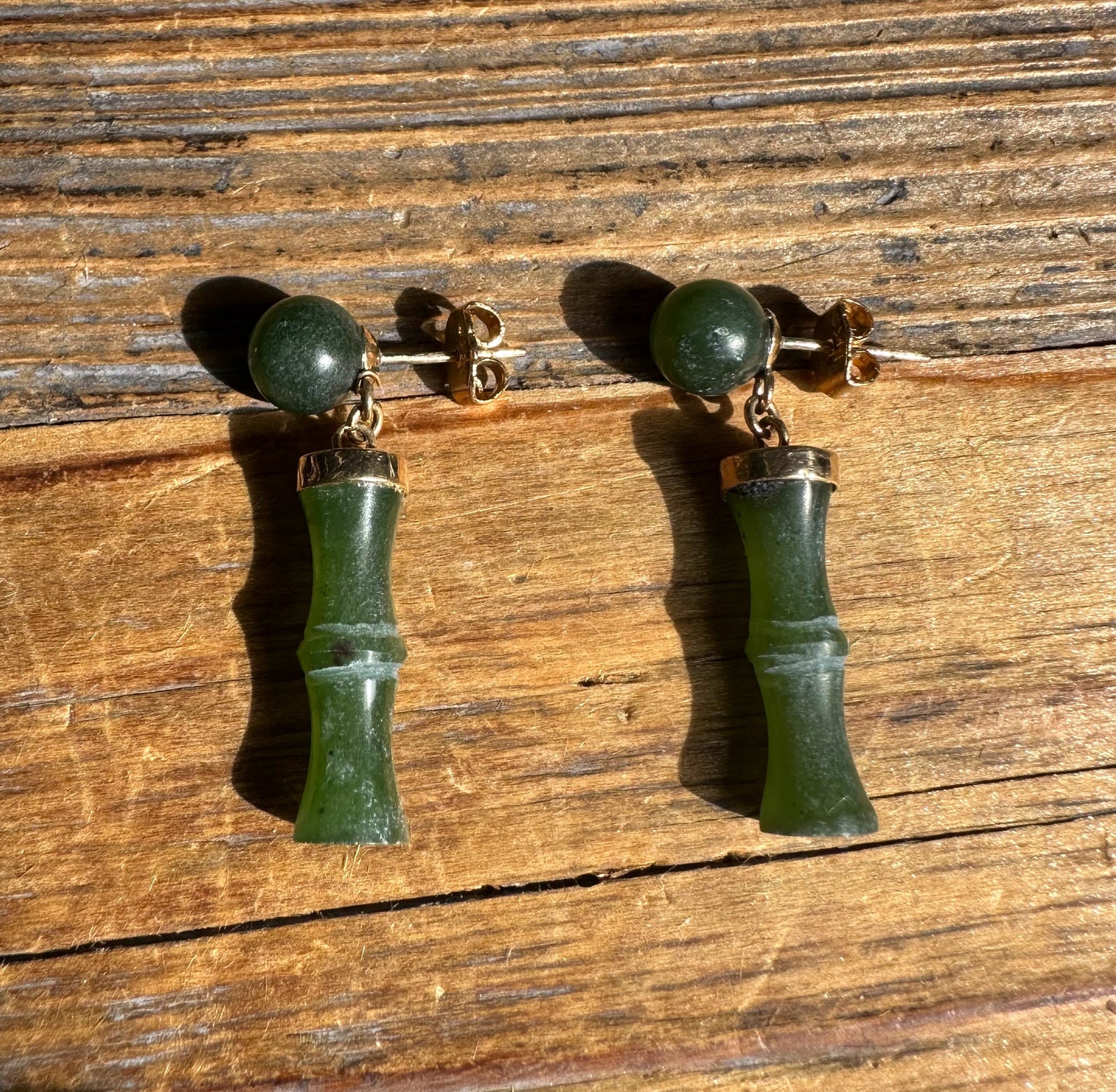 Vintage Jade Bamboo Earrings showing green jade beads and bamboo shaped drops on a rustic wooden surface