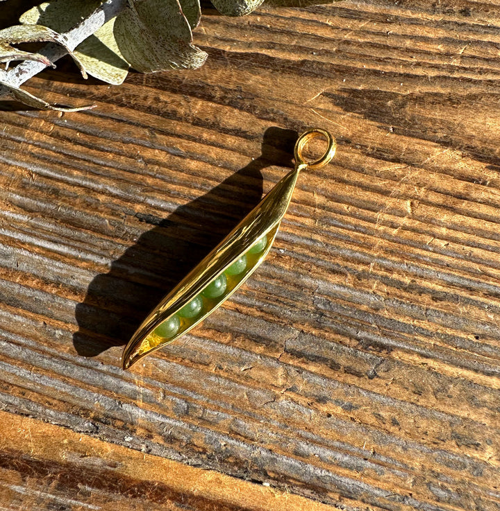 Gold tone jade peapod pendant with green jade beads inside