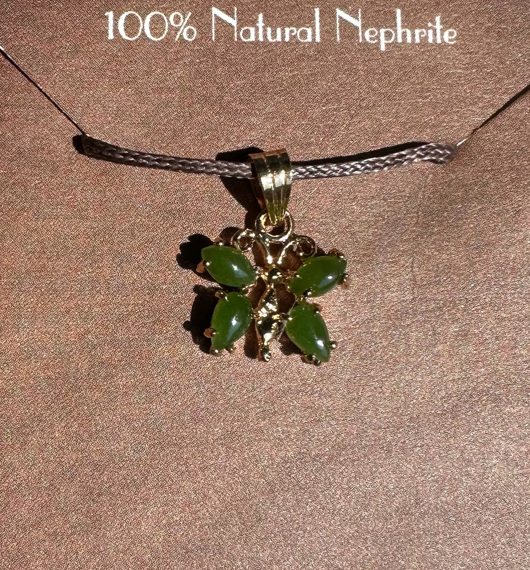 Jade butterfly pendant on a gray braided cord against a backdrop labeled 100% natural nephrite.