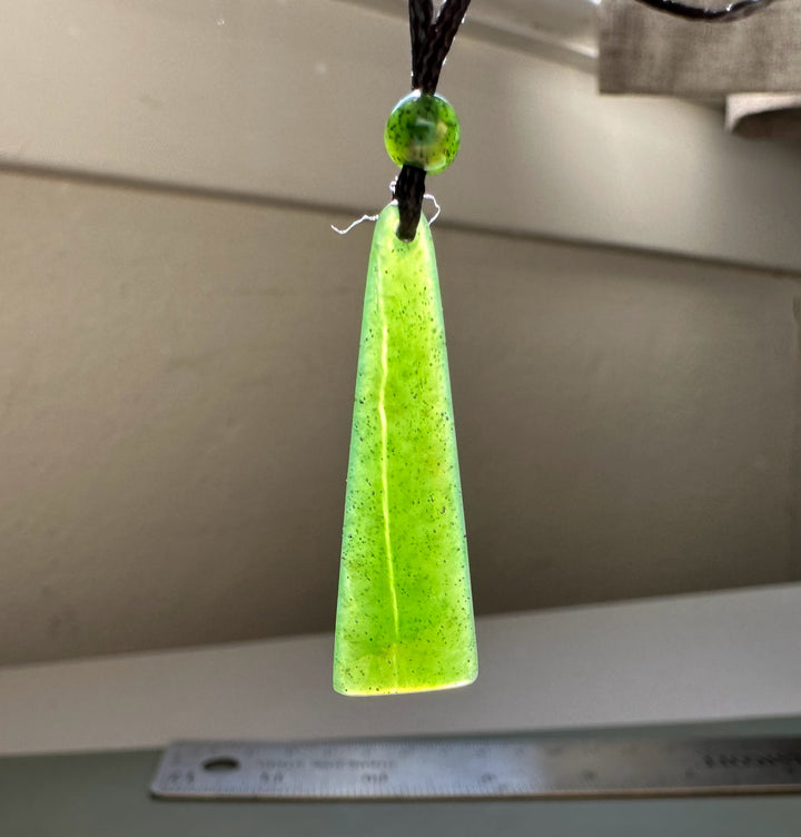 Canadian jade drop pendant in neon lime on a black cord with a small round bead above