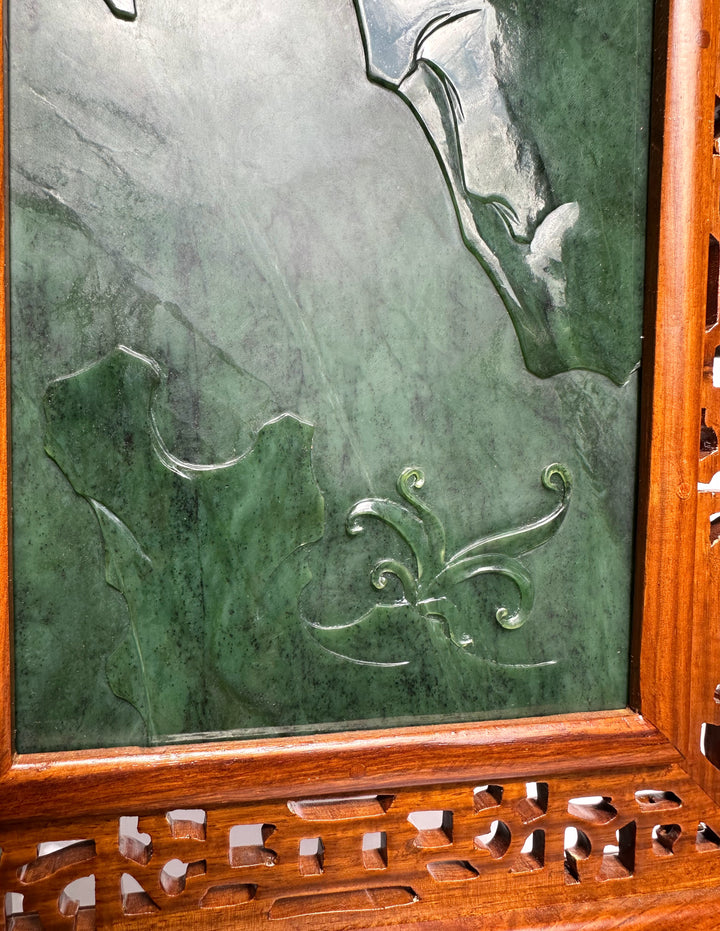 Section of Jade Chinese Cabbage Screen showing carved leaves and flowing floral scrolls on green jade within a wooden frame.