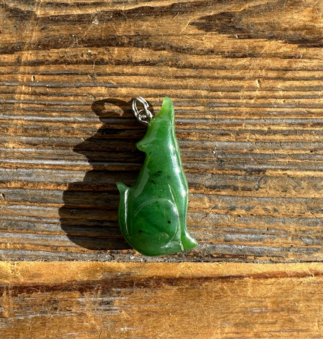 Jade wolf pendant carved from bright green jade with a silver bail