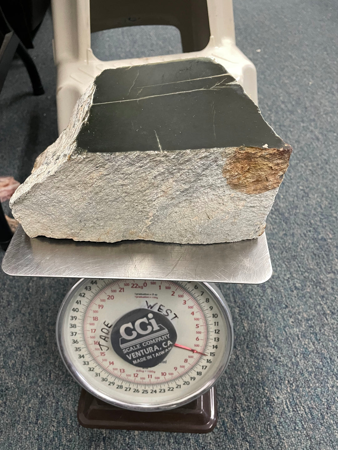 Wyoming Jade chunk on a round mechanical scale used for weight measurement.