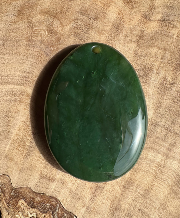 Green stone on a wooden surface