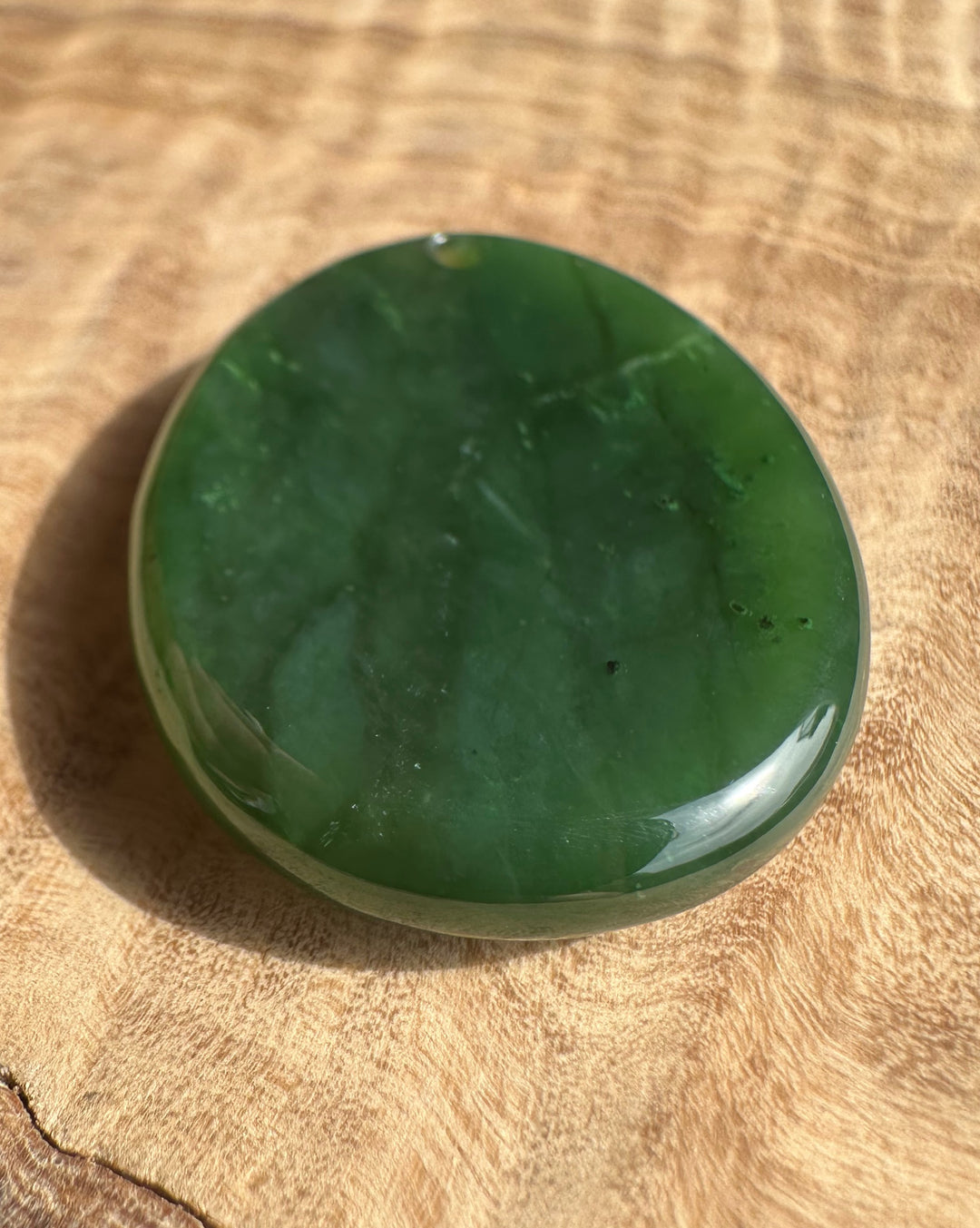 Green stone on a wooden surface