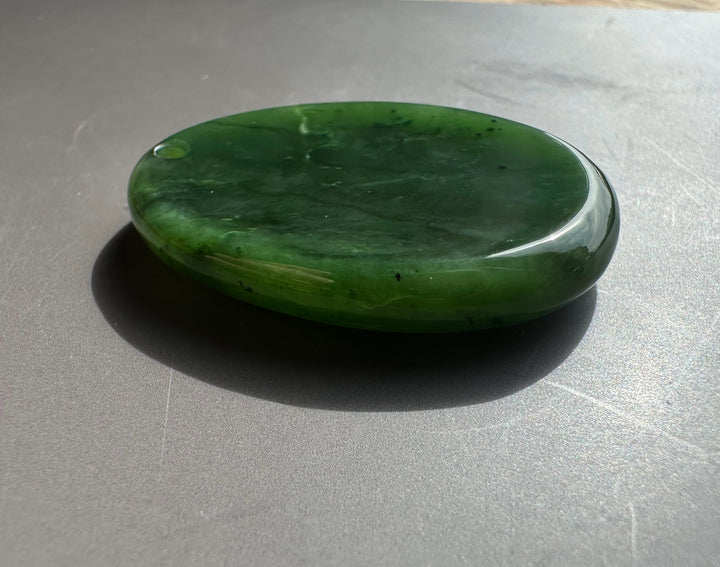 Green stone on a gray surface