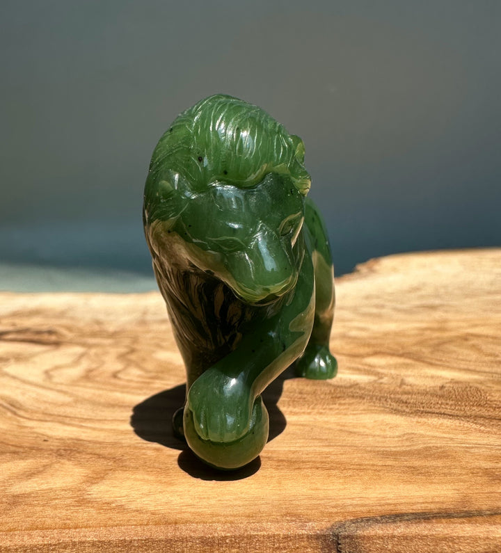 2.25 inch Canadian Jade Lion figurine on a wooden surface