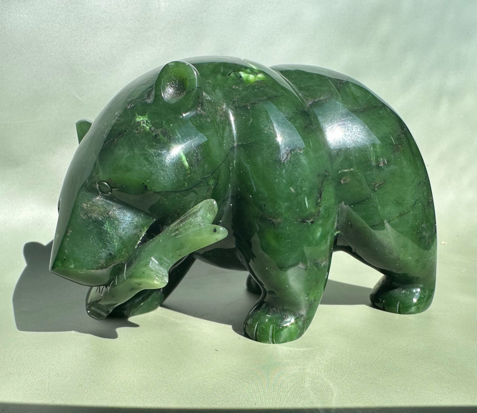 Canadian Jade Bear sculpture in emerald green jade with a polished surface.