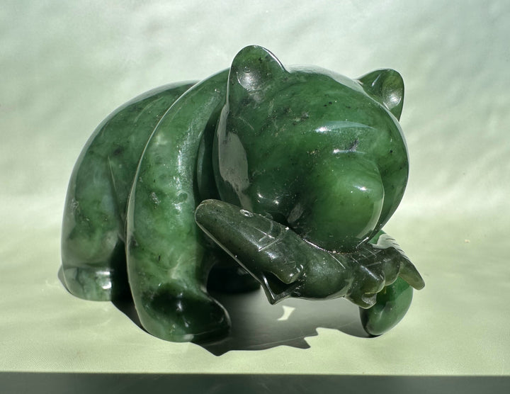 5 inch emerald jade bear sculpture with head bowed and front paws visible