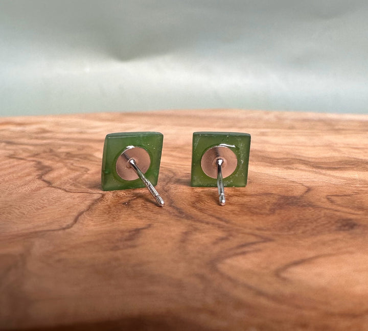 Back view of two green jade square stud earrings with copper backs and silver posts