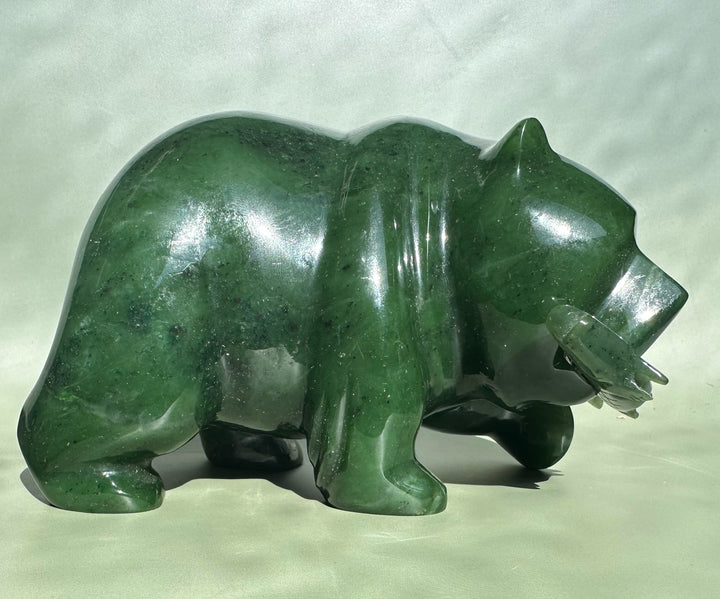 6 inch emerald jade bear sculpture in a low profile side view with head bowed
