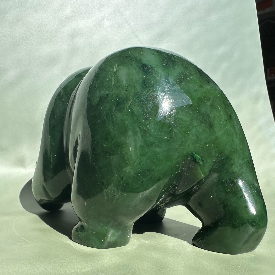 Rear view of a 6-inch Canadian jade bear sculpture in glossy green.