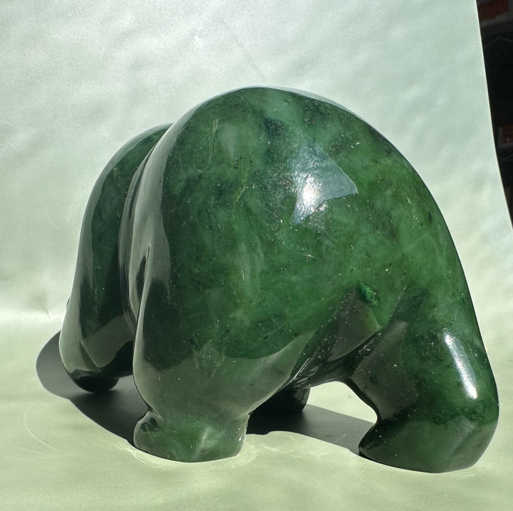 Rear view of a 6-inch Canadian jade bear sculpture in glossy green.
