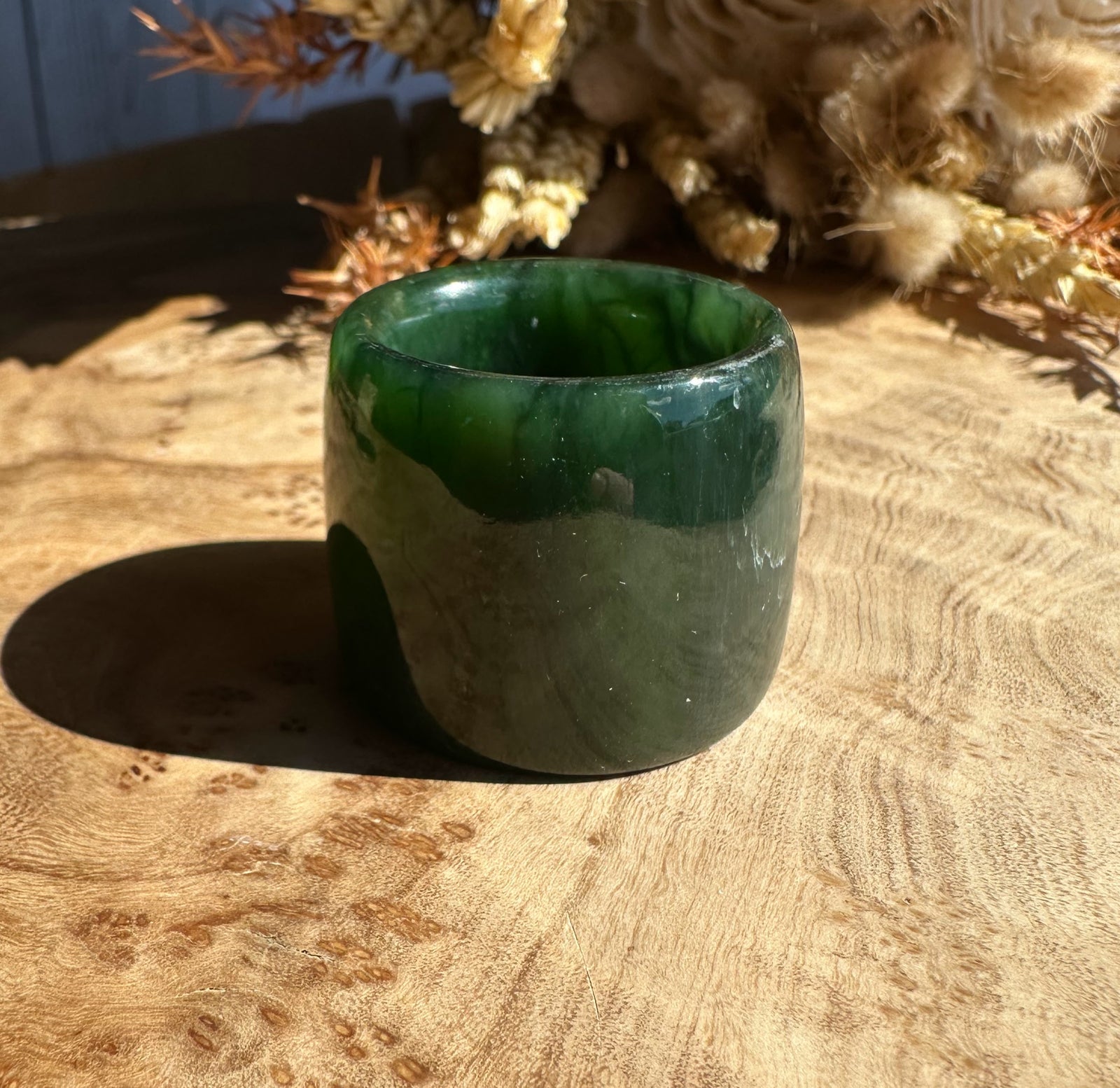 Canadian Ogden Jade Thumb Ring size 13, thick green jade band photographed on wood.