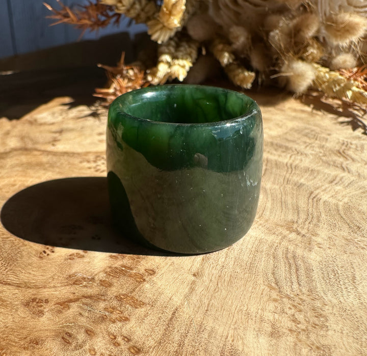 Canadian Ogden Jade Thumb Ring size 13, thick green jade band photographed on wood.