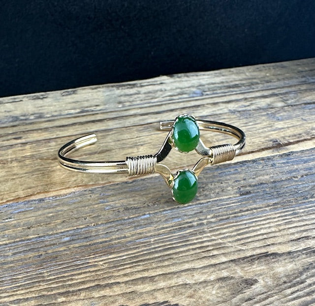 Vintage Jade Bracelet with two green beads linked by curved silver arms on a slim open cuff.