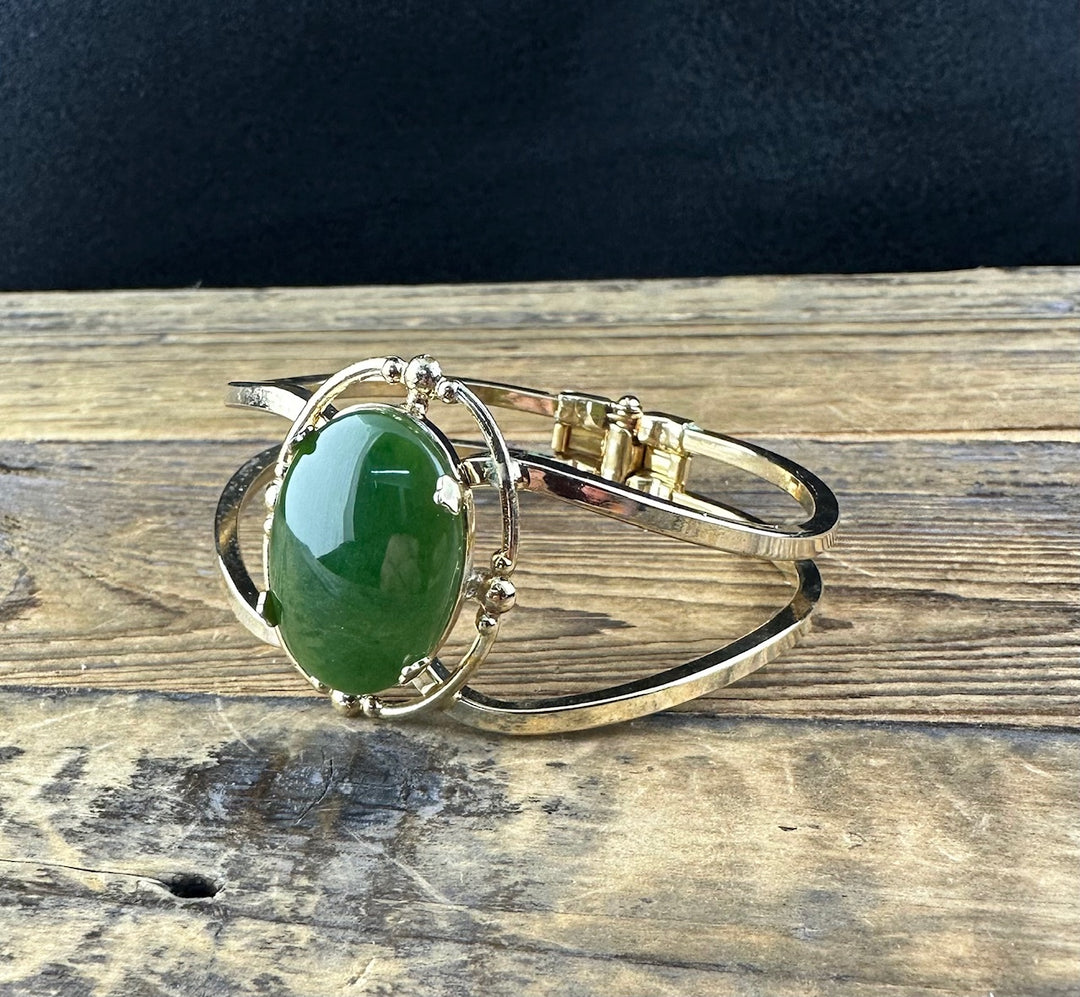 Side view of Vintage Jade Bracelet highlighting the green jade cabochon set in gold with decorative mounting