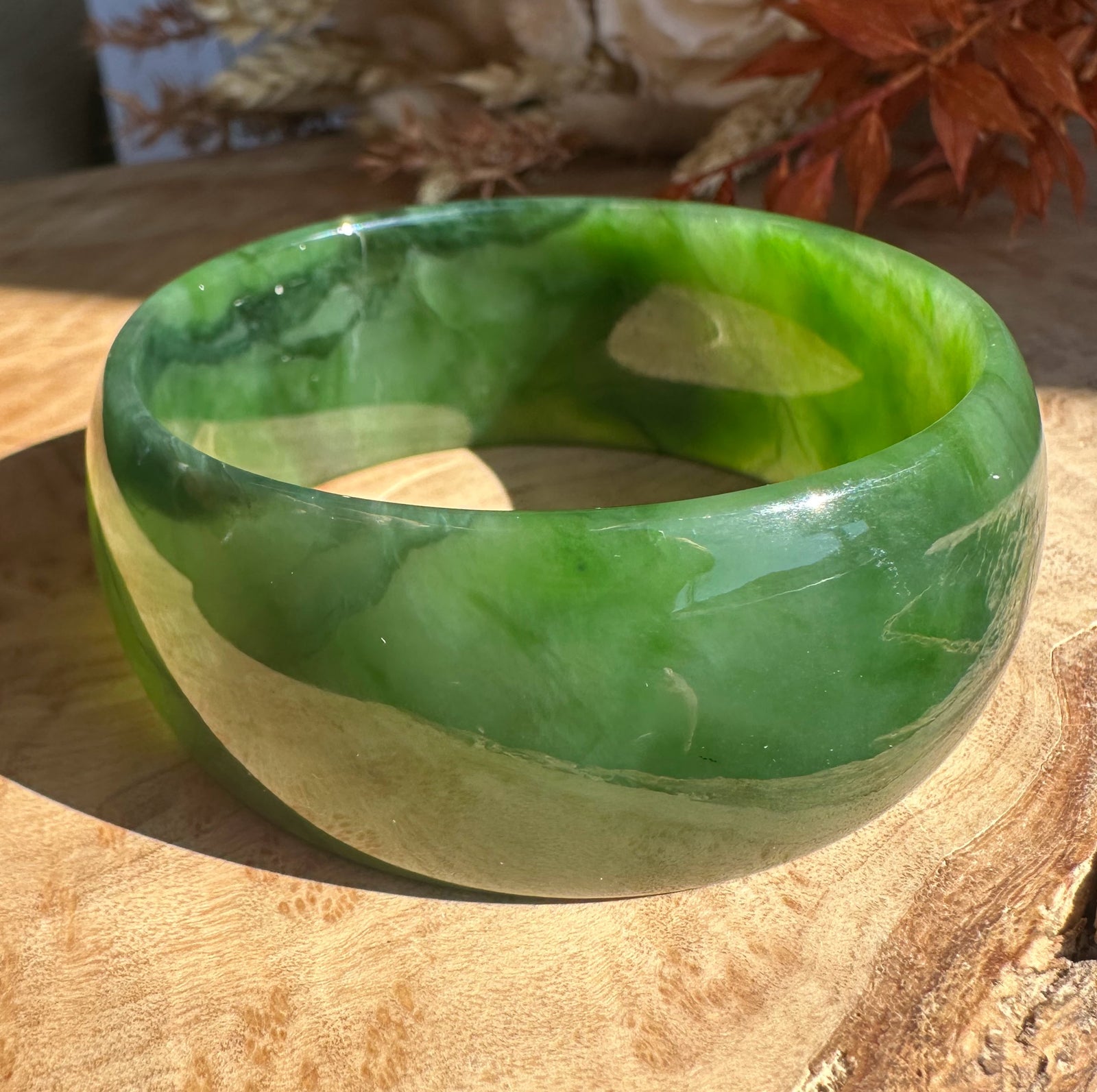 A grade Ogden jade bangle green with cream swirls, polished finish, size about 59.5 x 27 mm.