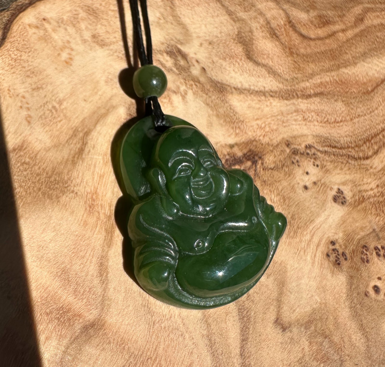 Green jade Happy Buddha pendant 26mm on black cord with round bead above