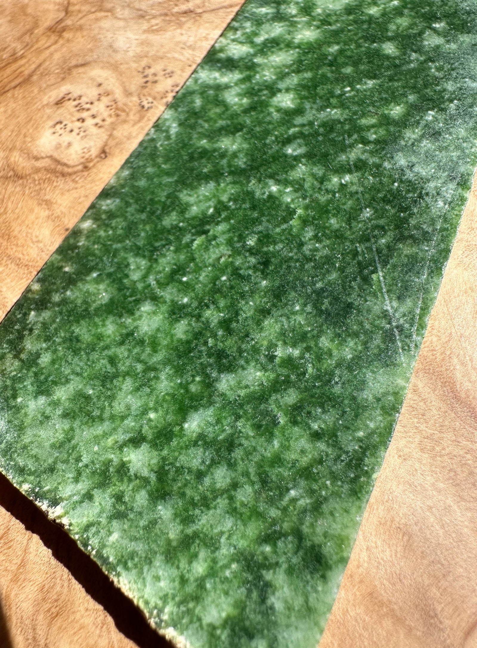 Wyoming Snowflake Jade slab dark green with mottled surface.