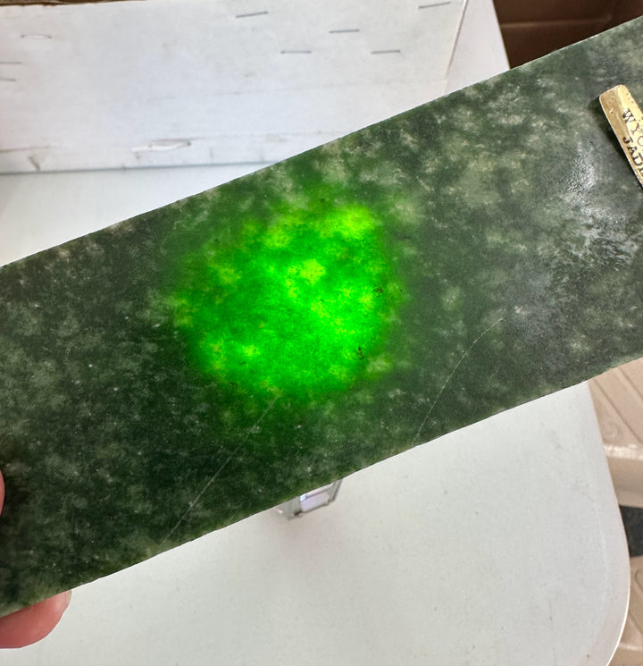 Wyoming Snowflake Jade slab in dark green with a bright neon green glow