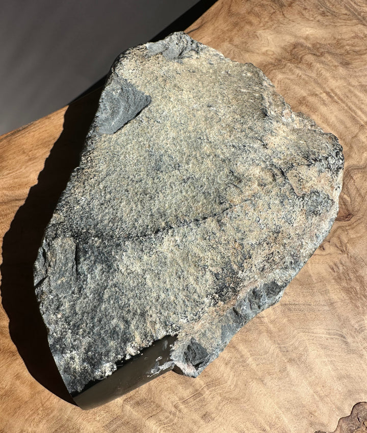 Wyoming rock specimen weighing 1.4 pounds on a wooden surface.