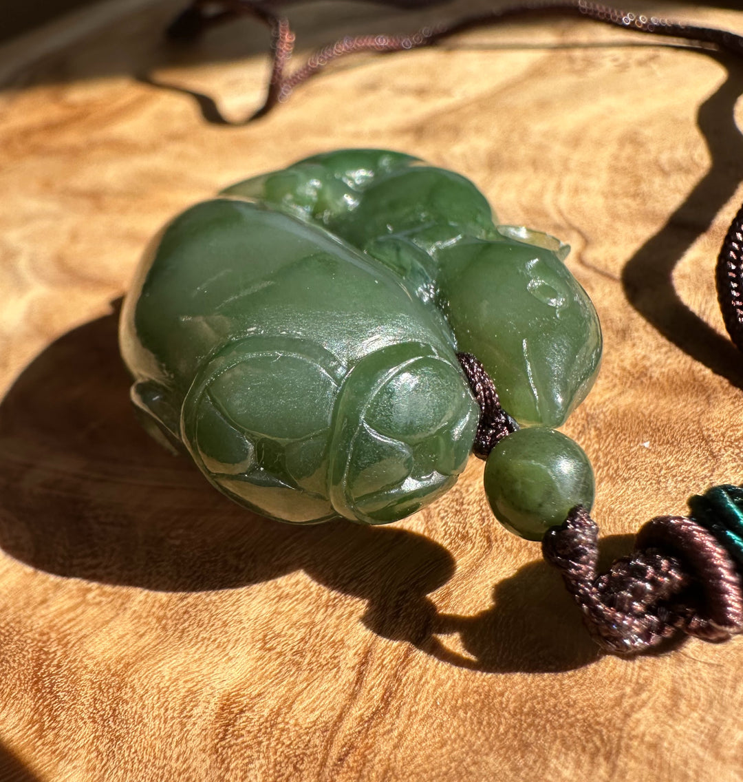 Green jade necklace on a wooden surface