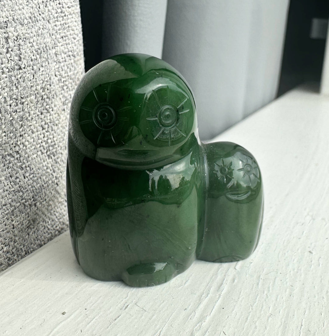 Close up of the Canadian Jade Owl and Owlet sculpture showing polished green jade and carved facial features