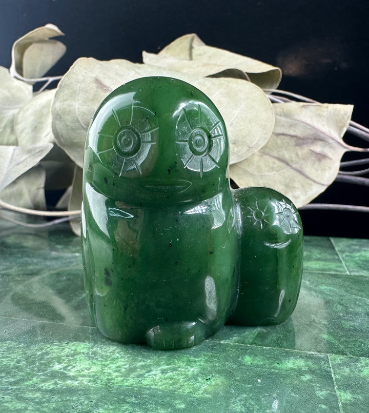 Pair of polished green jade owl figurines, a larger owl with a smaller owlet beside it.