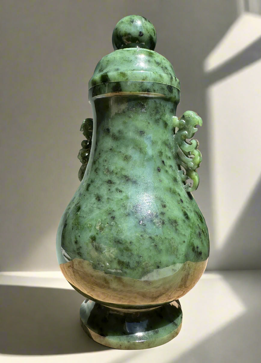 Green river jade vase with lid shown from a different angle highlighting the mottled jade and beige base.
