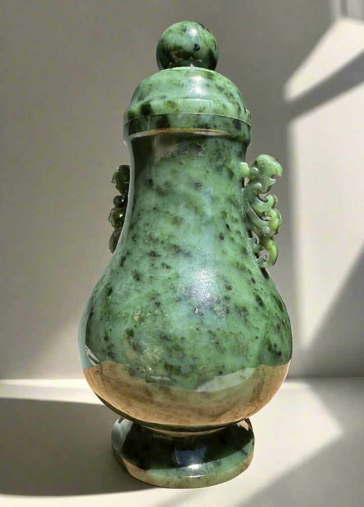 Green river jade vase with lid shown from a different angle highlighting the mottled jade and beige base.