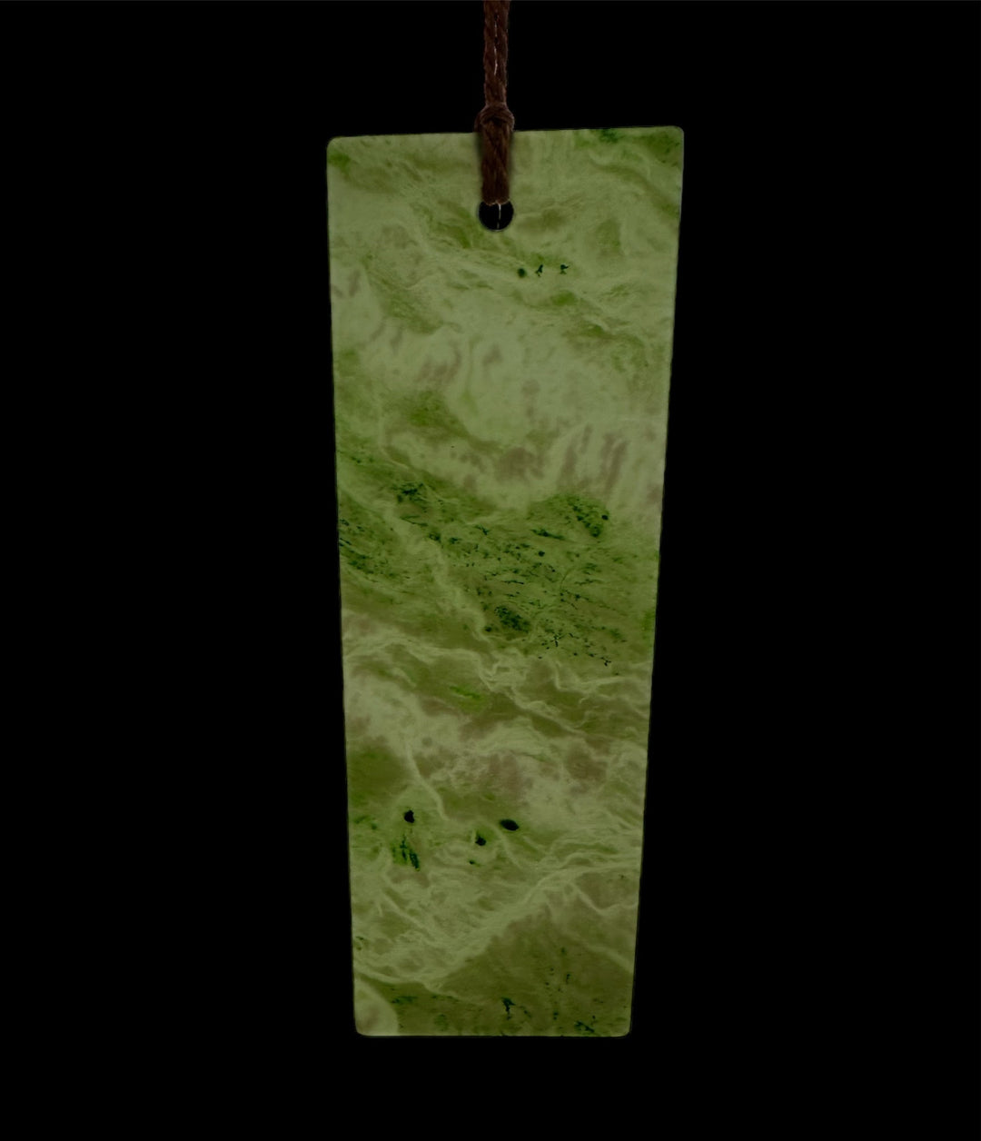 Six inch Canadian Jade bookmark with a pale green marbled pattern and a brown cord through the top hole.
