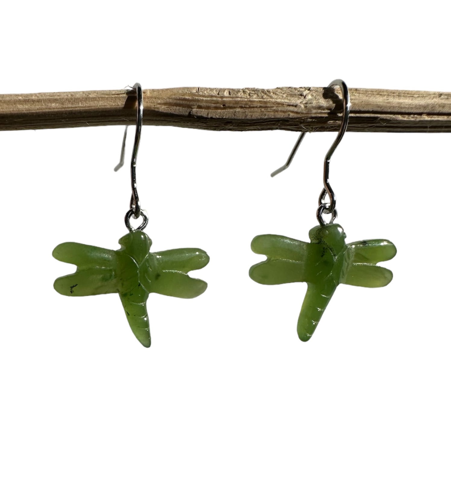 Pair of jade dragonfly earrings with green dragonfly charms on metal hooks.