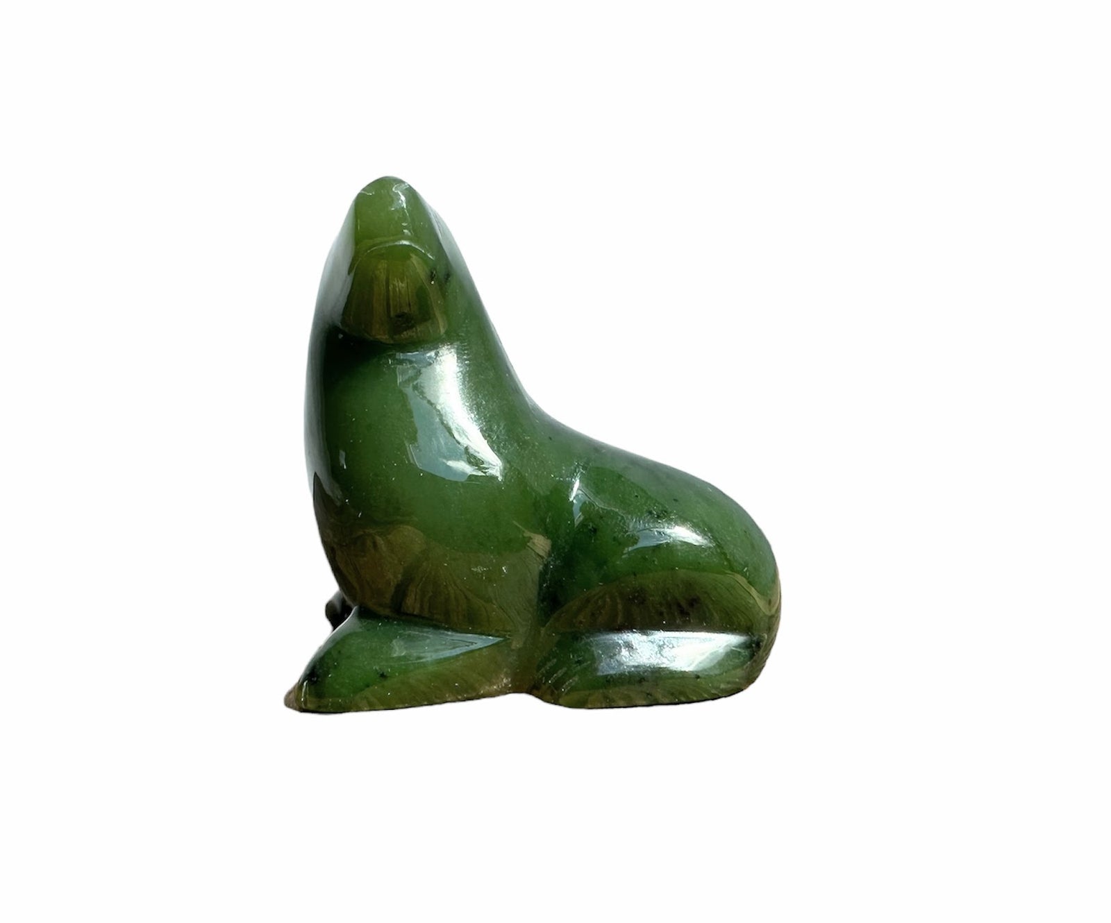 Green jade seal carved as a smooth seated animal form with a rounded top and polished surface