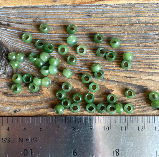 6mm Canadian Jade beads with large holes arranged beside a ruler on a wooden surface