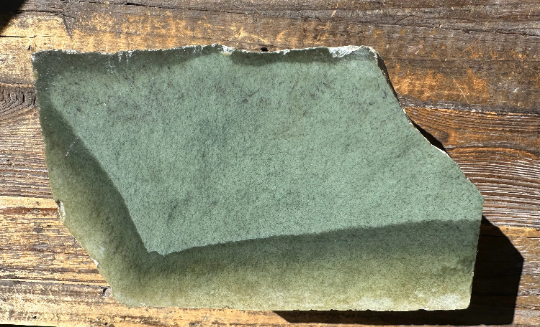 Wyoming Sage block with a velvety green surface resting on a wooden table.