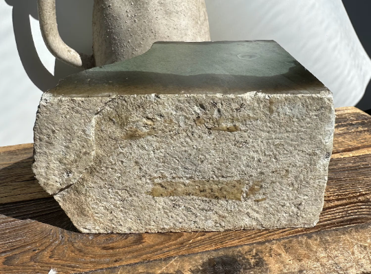 Wyoming Sage mineral slab bottom edge showing rough gray texture and natural striations on wood.