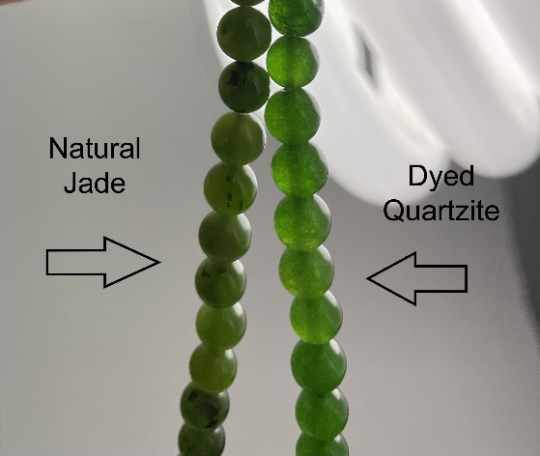 Two strands of green beads labeled &