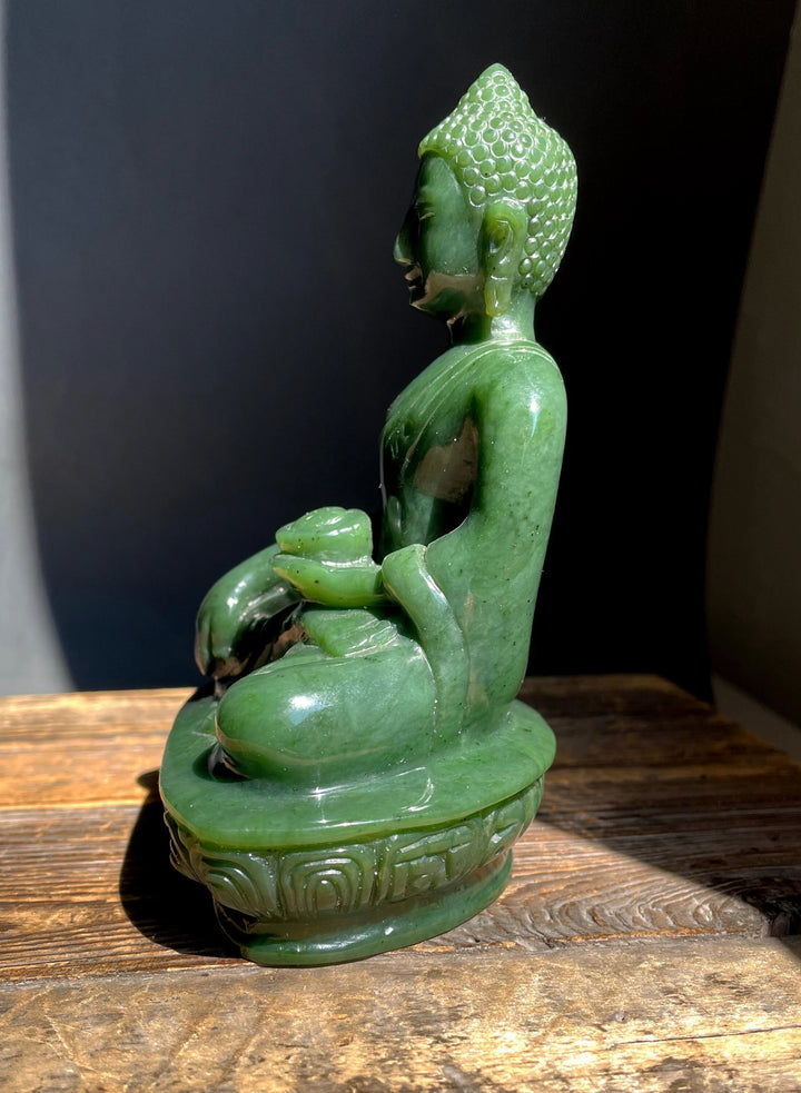 Five inch green nephrite jade Buddha statue carved from Canadian nephrite, seated in meditation