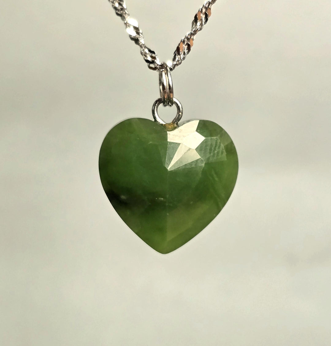 Faceted green nephrite jade heart pendant 16mm on a silver chain