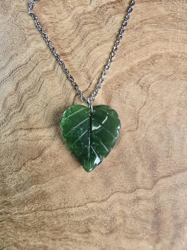 Green jade leaf pendant on a silver chain