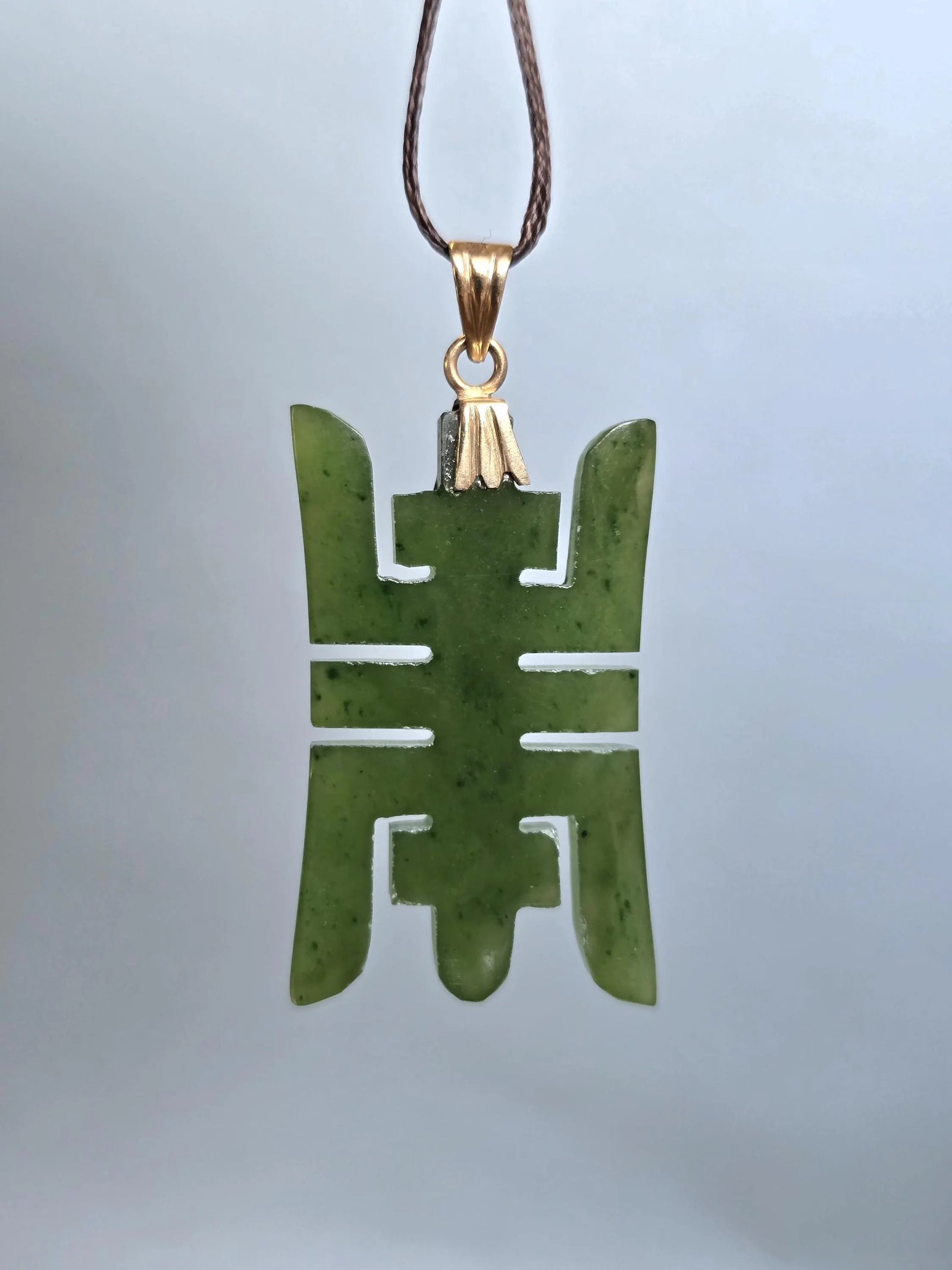 Green nephrite jade Longevity pendant with 14k plated bail on a brown cord