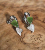 jade leaf earrings on wooden base