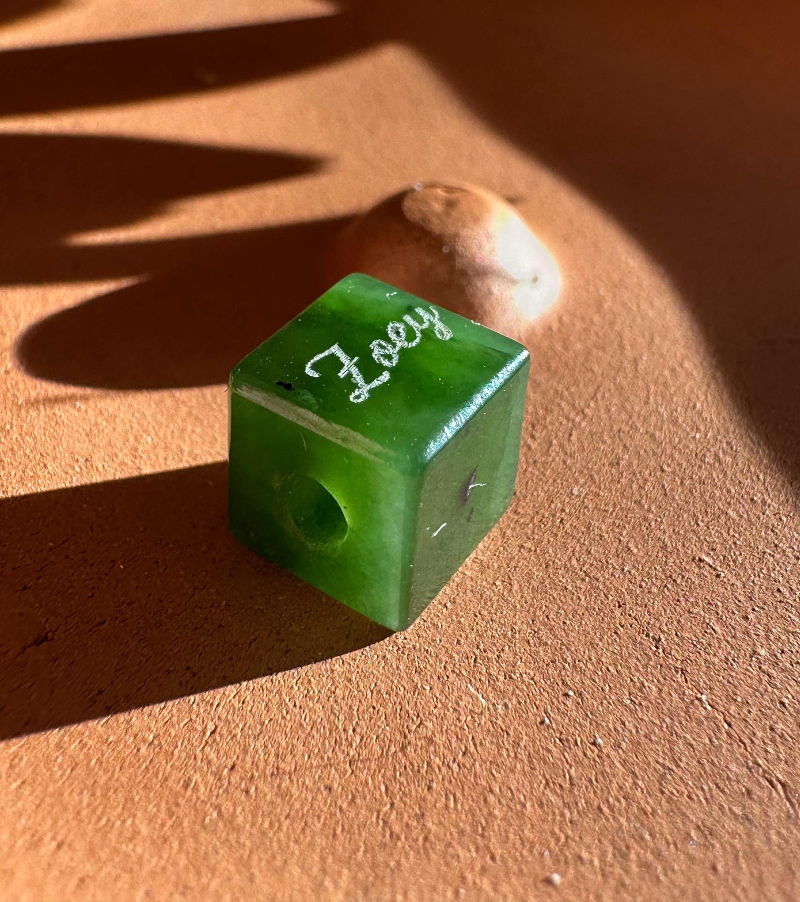Green cubic pendant with I Love You engraving and a hole for string
