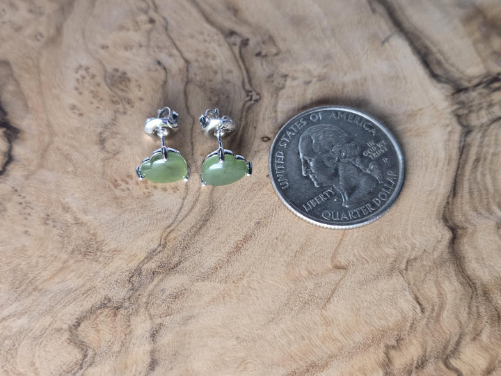 Silver teardrop earrings with green jade drops and black top stones shown beside a quarter for scale.