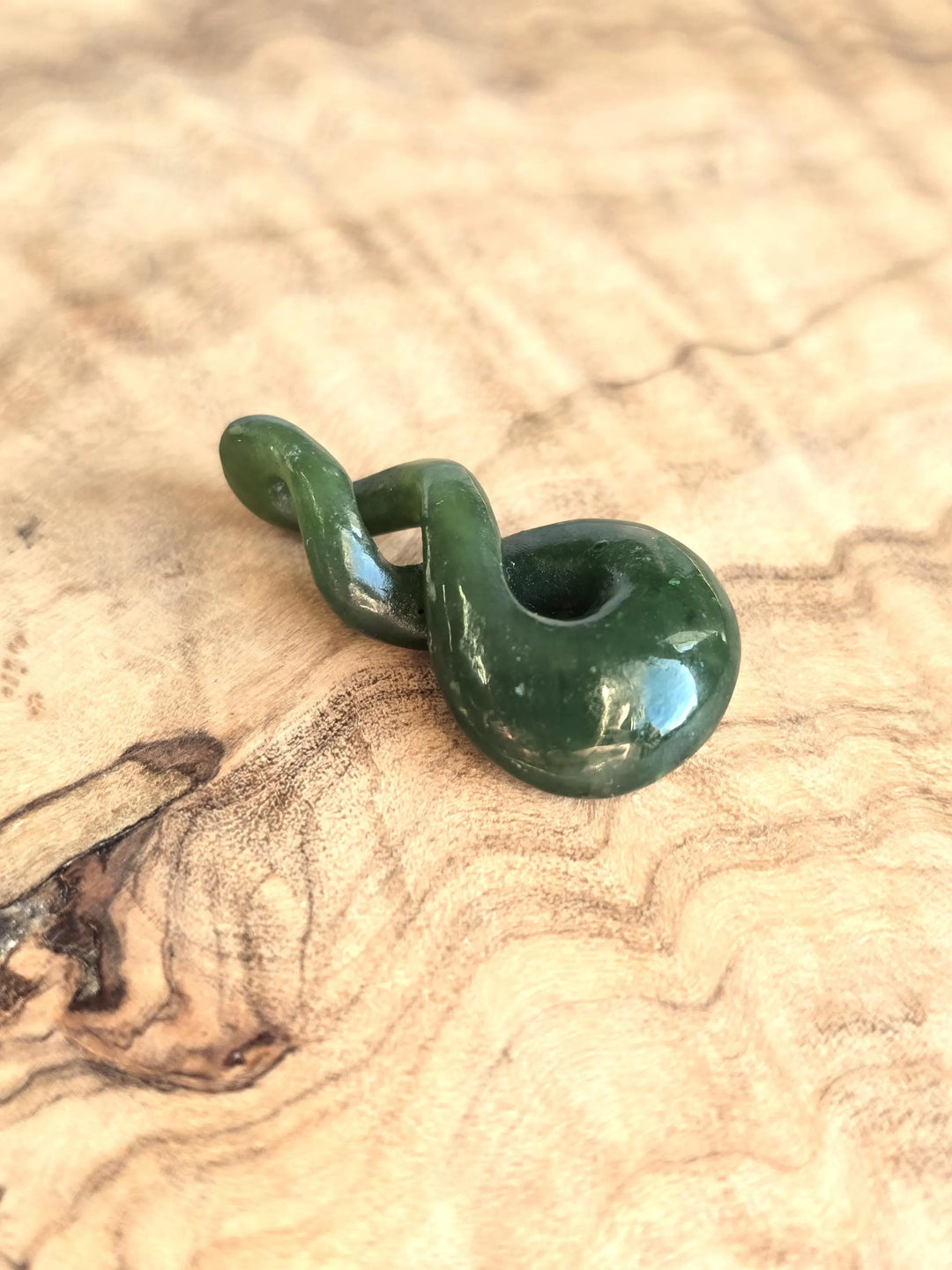 Green jade twist on a wooden base