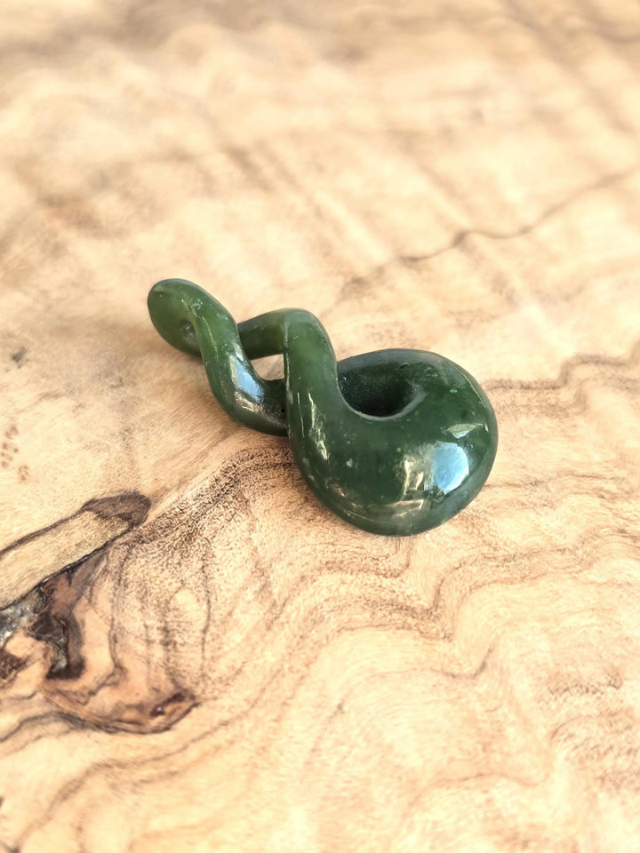 Green jade twist on a wooden base